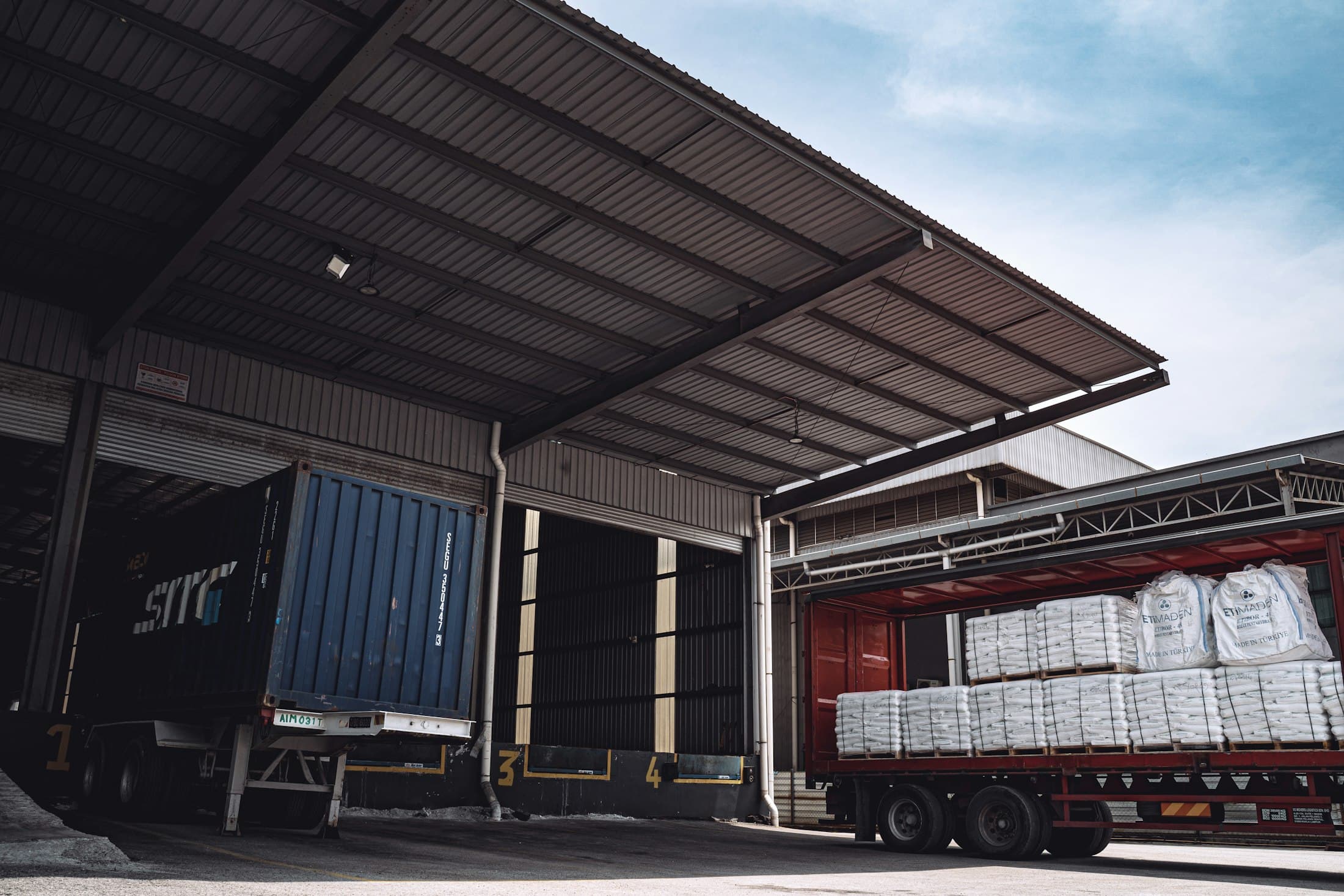 Bales loaded onto a truck at a warehouse dispatch bay