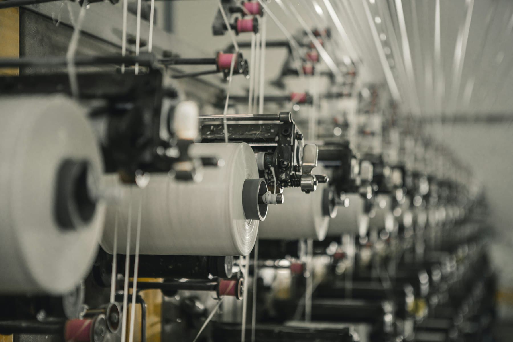 Row of winding frames building yarn packages