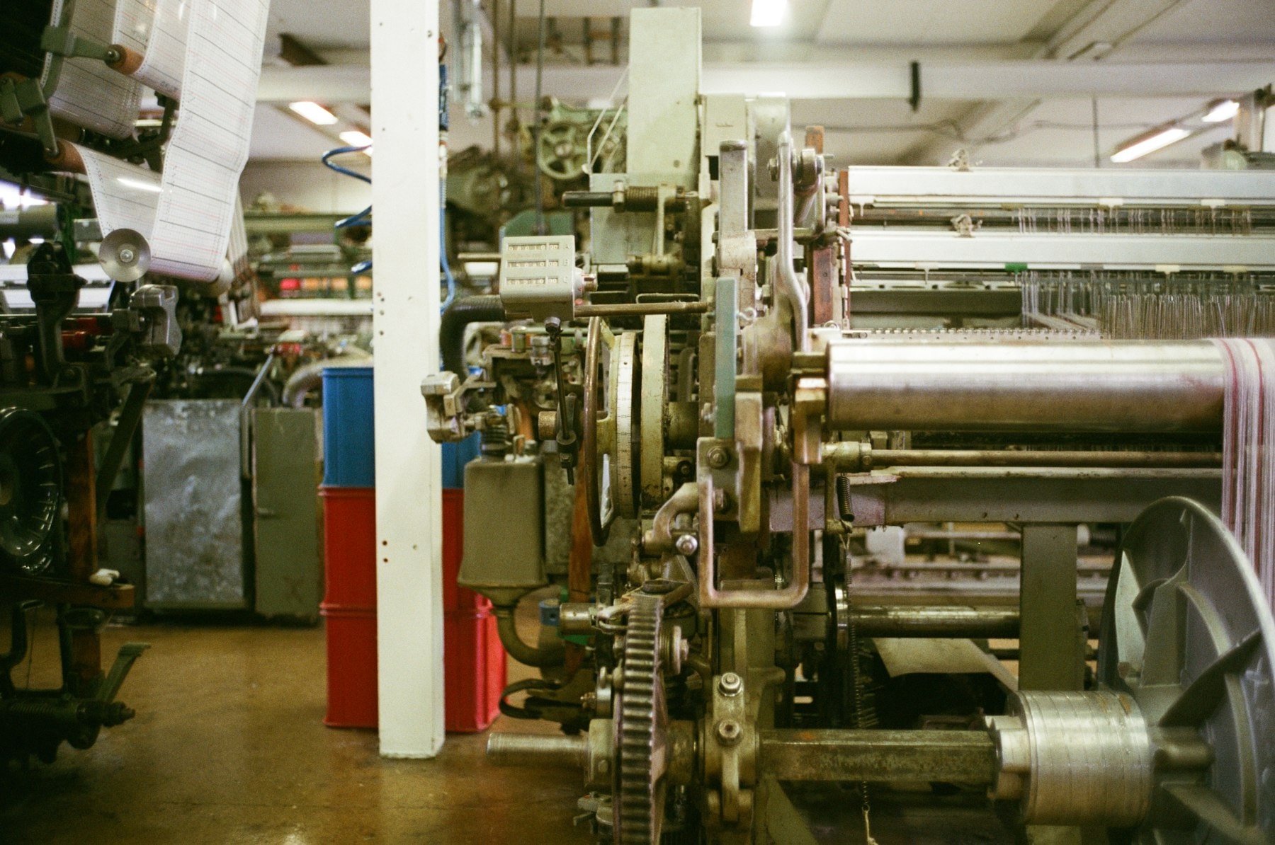 Grey fabric taking up on the loom's cloth roll