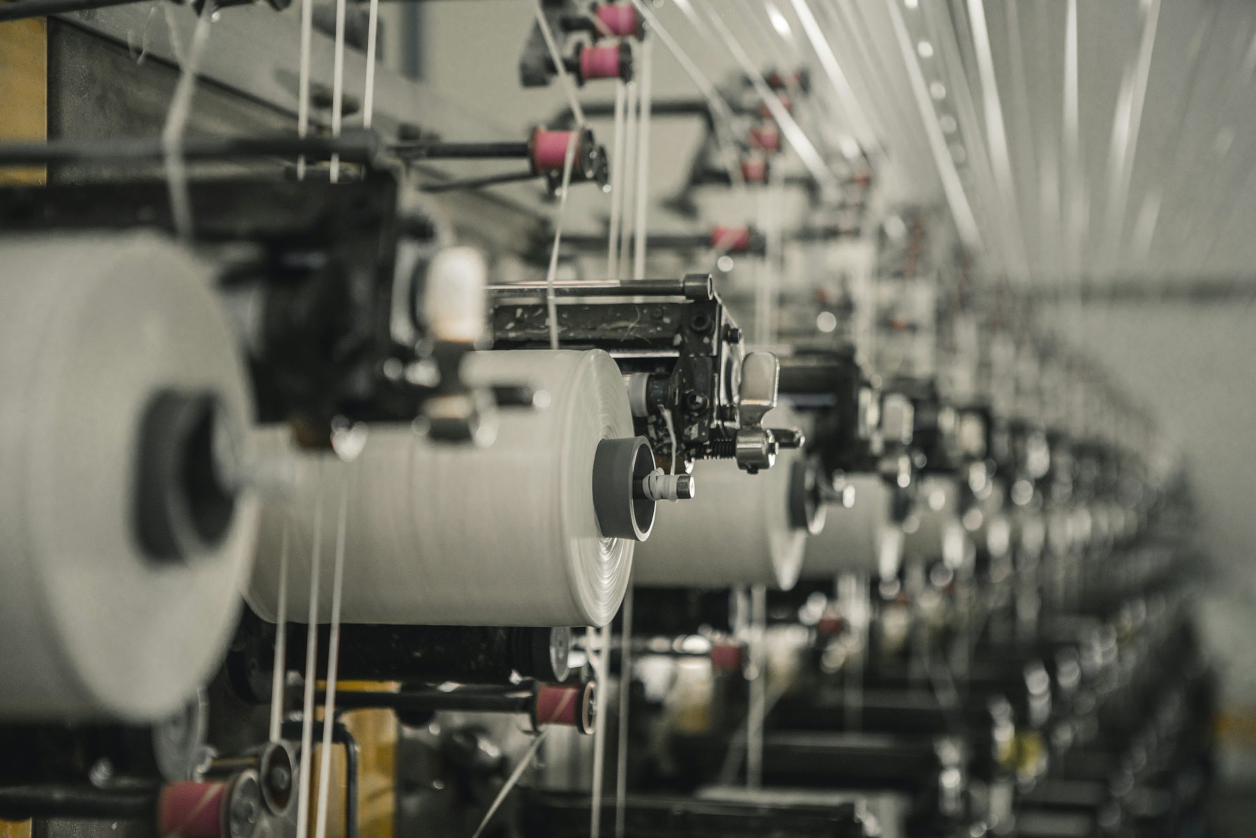 Row of winding frames building yarn packages